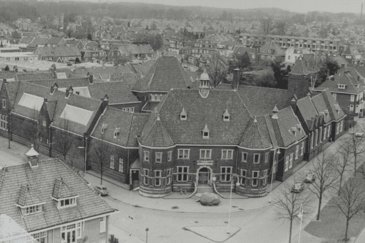 Precies een eeuw geleden, op 19 februari 1926, werd met de ondertekening van de schenkingsakte het fundament gelegd voor Rijksmuseum Twenthe. Edwina van Heek-Burr Ewing schonk op die dag een nieuw museumgebouw en de bijbehorende kunstcollectie aan de Nederlandse Staat. Daarmee gaf ze vorm aan de droom van haar overleden man, textielfabrikant Jan Bernard van Heek, en werd het museum officieel opgericht, dat 'blijvend en als zoodanig' bewaard moet blijven. Image Foto: Edwina van Heek Stichting Hoewel Jan Bernard van Heek het museum zelf niet meer zou meemaken, zorgde zijn echtgenote, Edwina, er met vastberadenheid voor dat zijn ideaal werkelijkheid werd. Honderd jaar later eren we haar daadkracht, visie en de maatschappelijke betrokkenheid die tot op de dag van vandaag voelbaar zijn in het museum. Edwina van Heek in de schijnwerpers Vanaf 8 maart 2026 is in Rijksmuseum Twenthe een focuspresentatie te zien over Edwina van Heek. De tentoonstelling is gebaseerd op nieuw historisch onderzoek van Bert-Jaap Koops en werpt licht op haar rol in de totstandkoming van het museum, een verhaal dat lange tijd onderbelicht bleef. De presentatie kwam tot stand in samenwerking met de Stichting Edwina van Heek en het archief van Landgoed Zonnebeek. Op weg naar 100 jaar Rijksmuseum Twenthe in 2030 Hoewel de oprichting in 1926 plaatsvond, opende Rijksmuseum Twenthe in 1930 zijn deuren voor het publiek. De herdenking van de schenkingsakte in 2026 markeert het begin van een vierjarige aanloop naar het officiële eeuwfeest in 2030, een moment waarop het museum groots zal terugblikken én vooruitkijken.